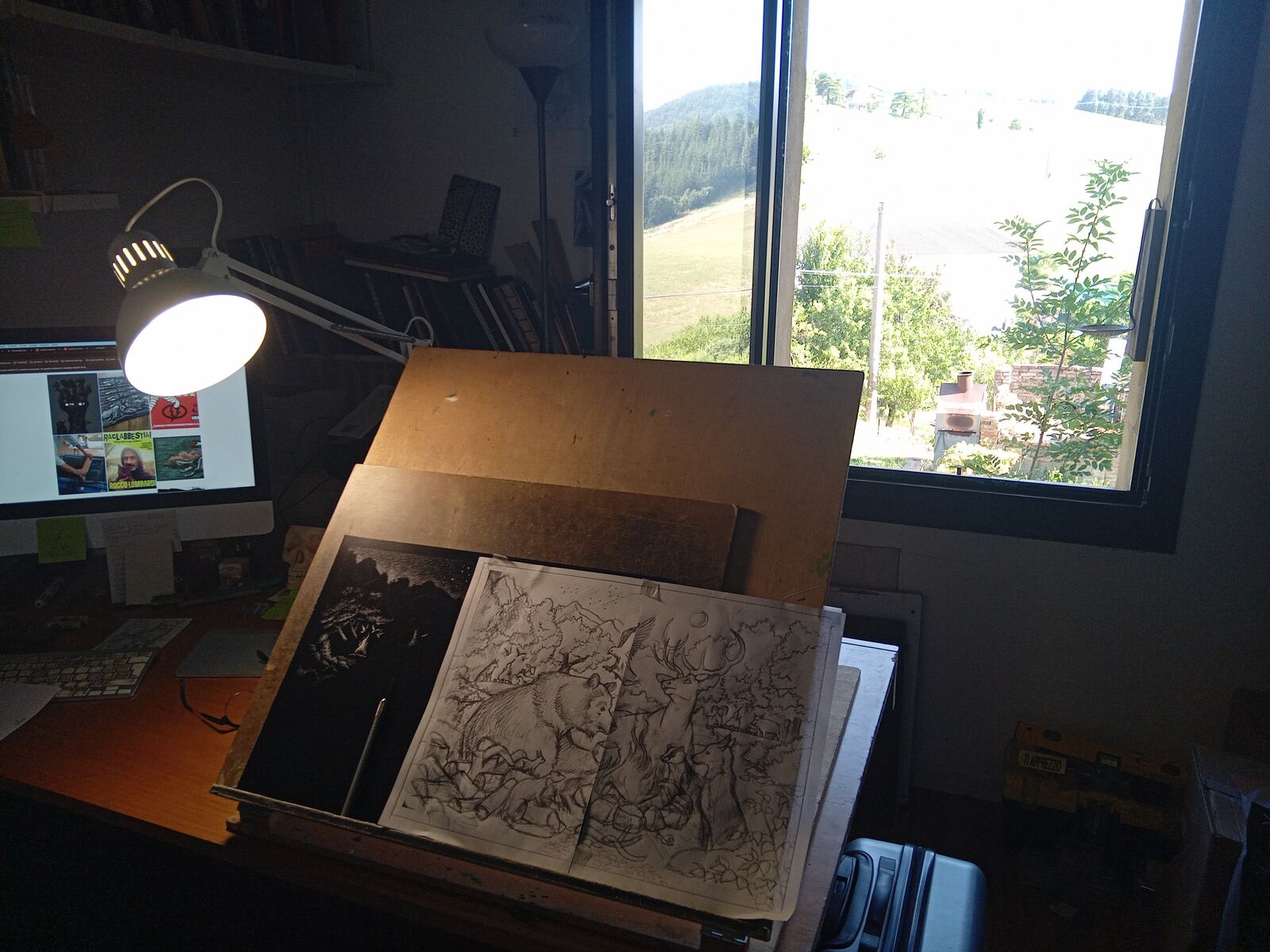 Rocco's drawing board, lamp and pencil composition ready beside the black artwork surface